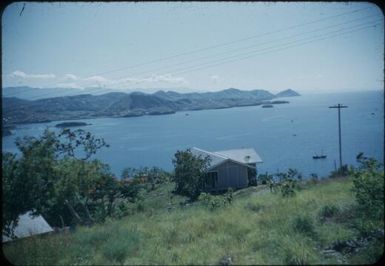 Looking down on the town and the coastline looking west : Port Moresby, Papua New Guinea, 1953 / Terence and Margaret Spencer