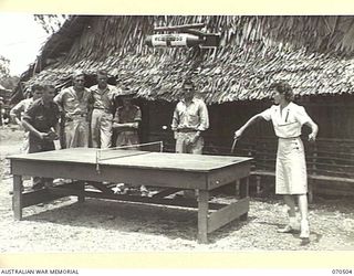 WARD'S DROME, PORT MORESBY AREA, PAPUA, 1944-02. AN AMERICAN RED CROSS HELPER, VIRGINIA RUGH, OF DECATUR, ILLINOIS, (1), PLAYING TABLE TENNIS WITH AN AUSTRALIAN SOLDIER AT THE AMERICAN RED CROSS ..