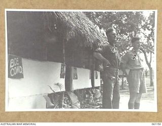 POM POM VALLEY, NEW GUINEA. 1943-12-03. TX2017 MAJOR R. G. SWAN, BRIGADE MAJOR, (LEFT) AND QX9500 CAPTAIN P. D. CONNOLLY, INTELLIGENCE OFFICER, (RIGHT) BOTH OF THE 18TH AUSTRALIAN INFANTRY BRIGADE