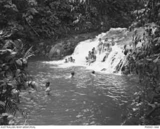 THE SOLOMON ISLANDS, 1945-02-26. AUSTRALIAN AND NEW ZEALAND SERVICEMEN TAKING IT EASY IN RIVER RAPIDS AND POOL. (RNZAF OFFICIAL PHOTOGRAPH.)