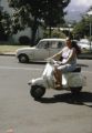 French Polynesia, woman driving scooter in Papeete