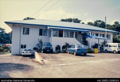 Vanuatu - White building with blue roof, clear sky