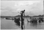 Man fishing at Sinalagu Harbour fishing weir with square net