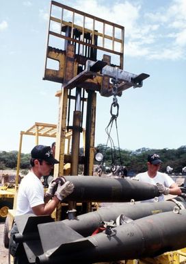 Members of the 3rd Munitions Maintenance Squadron load Mark 82 500-pound laser-guided bomb shells onto a bomb cart during Exercise Opportune Journey 4