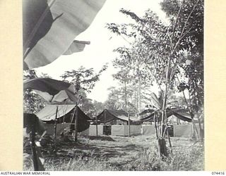 LAE, NEW GUINEA. 1944-07-01. AUSTRALIAN ARMY TENTS WHICH HAVE BEEN MODIFIED BY ADDING WALLS OF SISALCRAFT. THIS MODIFICATION ADDS TO THE WATERPROOFING AND INSULATING QUALITIES OF THE ISSUE TENTS