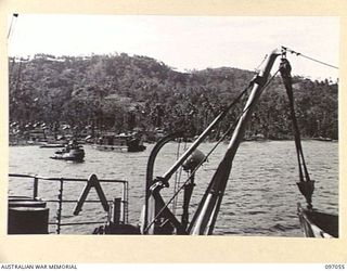 RABAUL, NEW BRITAIN. 1945-09-20. A REFRIGERATOR BARGE AND AN ARMY TUG IN SIMPSON HARBOUR SEEN FROM THE ANDREW BRISCOE, THE FIRST VICTORY SHIP TO REACH RABAUL WITH SUPPLIES