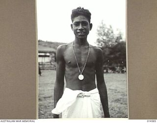 1943-04-05. NEW GUINEA. PAUL MEA, A PAPUAN SCHOOLBOY WITH HIS COMMONWEALTH MEDAL. PAUL RESCUED TWO AMERICAN SOLDIERS FROM A FLOODED RIVER IN NEW GUINEA. (NEGATIVE BY N. BROWN)