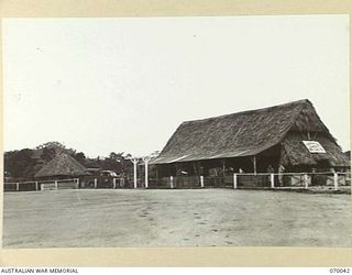 PORT MORESBY, NEW GUINEA. 1944-01-22. THE RECREATION HUT AND BARBERS SHOP VIEWED FROM THE CRICKET OVAL IN THE CAMP AREA OF THE 2/101ST GENERAL TRANSPORT COMPANY. THEY WERE BUILT BY THE COMPANY AND ..