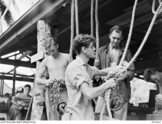 MILNE BAY, NEW GUINEA. 1943-06-29. VX72916 SAPPER R.W. COLLINS, VX77257 SAPPER E.A. WHITEOAK, AND NX27905 SAPPER E.E. MOORE, RIGGERS OF "C" GROUP, 2/3RD AUSTRALIAN DOCKS OPERATING COMPANY, ROYAL ..