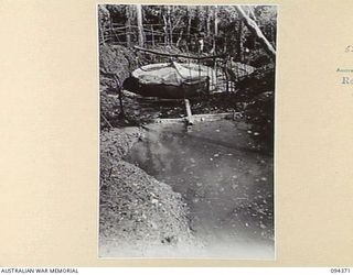 MAPRIK AREA, YAMIL 2, NEW GUINEA. 1945-07-20. A RUNNING STREAM HIGH IN THE PRINCE ALEXANDER MOUNTAIN RANGE DAMMED AND DIRECTED TO A 350-CANVAS WATER TANK, TO SUPPLY WATER TO THE MAIN DRESSING ..