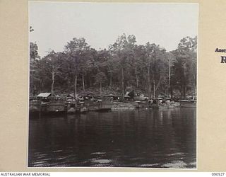 JACQUINOT BAY, NEW BRITAIN. 1945-04-12. A GENERAL VIEW SHOWING BARGES AND REPAIR BARGES LINING THE BANKS AWAITING REPAIRS ETC. THEY BELONG TO 3016 ENGINEER BOAT MAINTENANCE COMPANY (US ARMY), ..