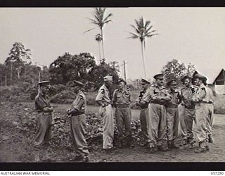 SOPUTA, NEW GUINEA. 1943-09-29. AUSTRALIAN AND UNITED STATES OFFICERS AWAITING THE ARRIVAL OF THE FUNERAL CORTEGE OF BRIGADIER (BRIG) R. B. SUTHERLAND. LEFT TO RIGHT: WX5 BRIG R. L. SANDOVER ED; ..