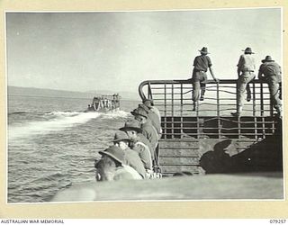WIDE BAY, NEW BRITAIN. 1945-02-17. TROOPS OF THE 14/32ND INFANTRY BATTALION LINE THE SIDES OF THE LANDING BARGES OF THE 594TH ENGINEER BOAT AND SHORE REGIMENT, B COMPANY UNITED STATES ARMY AS THE ..
