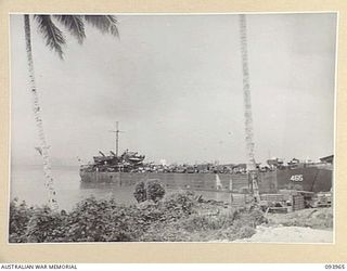 PALMALMAL PLANTATION, JACQUINOT BAY, NEW BRITAIN, 1945-07-09. A UNITED STATES LANDING SHIP, TANK (LST) ARRIVING AT BASE AREA BEACHHEAD WITH STORES AND EQUIPMENT FOR THE ROYAL NEW ZEALAND AIR FORCE