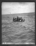 Group of men on canoe, coming from Anuta to greet visitors