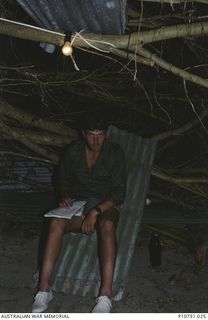 Sapper Steve Ash writing home from Pangi Villiage, Lifuka Island.This image relates to the service of Michael Church, 17 Construction Squadron, who was a member of the Cyclone Isaac mission in ..