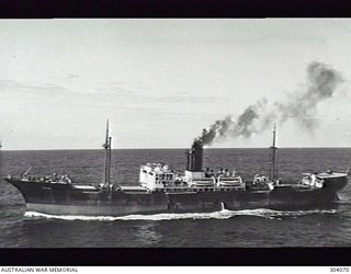 AERIAL PORT SIDE VIEW OF THE BRITISH CARGO VESSEL TRIONA WHICH ESCAPED AN ENCOUNTER WITH THE GERMAN AUXILIARY CRUISER ORION IN THE SOUTH CORAL SEA ON 10 AUGUST 1940 ONLY TO BE SUNK BY THAT SHIP AND ..