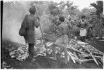 Men preparing leaf oven for the pudding