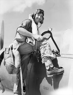 TOROKINA, BOUGAINVILLE ISLAND, SOLOMON ISLANDS. C. 1945-02. 266409 SQUADRON LEADER N. PARRY AFC OF DENILIQUIN, NSW, HEAVILY LADEN WITH MAE WEST (LIFEJACKET), PARACHUTE AND JUNGLE KIT, CLIMBS INTO A ..