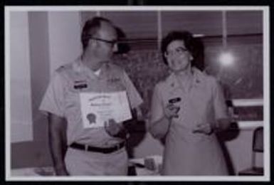 Photograph of Nancy Ashley Myers receiving a Certificate of Membership in the American Society of Military Comptrollers