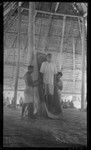 Huge food bowl in maneaba meeting house of Tabiteuea, said to belong to Kourabi; man standing in bowl is descendent of Kourabi and clan chief