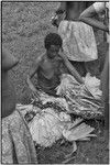 Mortuary ceremony: woman with banana leaf bundles (wealth items) for exchange