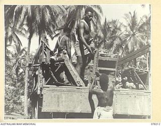 AITAPE, NEW GUINEA. 1945-01-08. AUSTRALIAN AND NEW GUINEA ADMINISTRATION UNIT NATIVES LOADING STORES AND SUPPLIES FOR THE "JOCK FORCE" EXPEDITION ABOARD A THREE TON TRUCK FOR THE TRIP TO YAKAMUL. ..