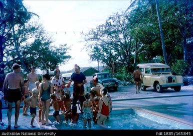 Children and adults in a wading pool