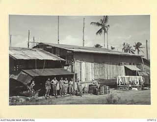 ALEXISHAFEN, NEW GUINEA. 1944-07-16. MEMBERS OF THE STAFF OF THE 2/15TH FIELD AMBULANCE ON THE VERANDAH OF THE OLD MISSION BUILDING WHICH THEY HAVE CONVERTED INTO A WARD FOR SCRUB TYPHUS CASES