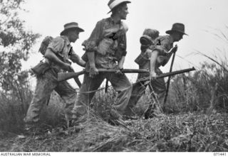 PORT MORESBY, PAPUA. 1944-03-24. Q271046 PRIVATE C.E. BESS (1), QX54630 PRIVATE J.W. MILES (2) AND Q144463 PRIVATE J. LENTELL (3), POSING FOR A PHOTOGRAPH TAKEN FOR V93667 CAPTAIN G.H. ALLEN, A ..