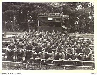 GREEN ISLAND, BOUGAINVILLE AREA, SOLOMON ISLANDS. 1944-12-19. HQ 23 INFANTRY BRIGADE TROOPS FROM VARIOUS ADMINISTRATIVE OFFICES IN THE PICTURE ARENA. THE NOTICE ON THE PROJECTION BOX AT THE ..