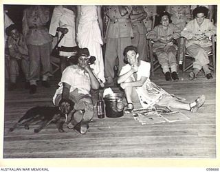 LAE, NEW GUINEA. 1945-11-08. CORPORAL I.M. BARNETT (1) AND PRIVATE E.M. LEE (2), WHO WERE FIRST AND SECOND PRIZE WINNERS IN THE MOST ORIGINAL COSTUME SECTION OF THE FANCY DRESS PARTY HELD BY ..