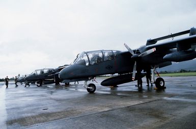 OV-10 Bronco aircraft from the 22nd Tactical Air Support Squadron (TASS) are parked on the flight line. The squadron has just returned from Korea after participation in Exercise TEAM SPIRIT '84