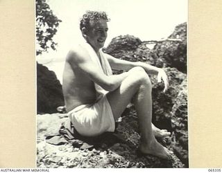 KILIGIA, NEW GUINEA. 1944-03-20. A BARE-CHESTED MR PAUL BECKER OF THE AUSTRALIAN PUBLIC RELATIONS FIELD UNIT