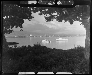 Apia waterfront, Upolu, Samoa, showing two boats in the lagoon and buildings in the background