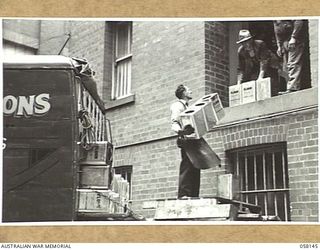 KENSINGTON, VIC. 1943-10-23. NEW TINS ARRIVING AT MESSRS KIMPTON & SONS, FLOUR MILL, TO BE FILLED AND SEALED FOR DESPATCH TO THE TROOPS IN NEW GUINEA