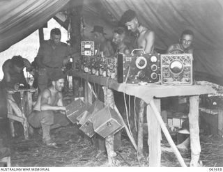 DUMPU, RAMU VALLEY, NEW GUINEA. 1943-11-29. RADIO AND TELEPHONE MAINTENANCE SECTION OF HEADQUARTERS, 7TH AUSTRALIAN DIVISION SIGNALS. SHOWN ARE: QX13067 SIGNALMAN W. J. FROST (1); VX82477 ..