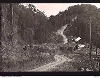 REINHOLD HIGHWAY, NEW GUINEA. 1943-08-24. PORTION OF THE ROAD CONSTRUCTED BY THE TROOPS OF HEADQUARTERS, ROYAL AUSTRALIAN ENGINEERS, 11TH AUSTRALIAN DIVISION BETWEEN JOHNSON'S GAP AND EDIE CREEK. ..