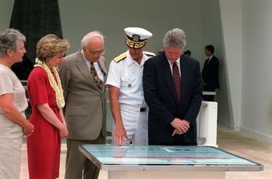 President William Jefferson Clinton, Adm. Charles Larson, commander-in-chief, U.S. Pacific Fleet, Secretary of Defense Les Aspin, Mrs. Clinton and Mrs. Aspin study a chart illustrating the wreck of the battleship USS ARIZONA (BB-39) during their visit aboard the ARIZONA (BB-39) Memorial. The Clintons are in Hawaii to tour area military installations