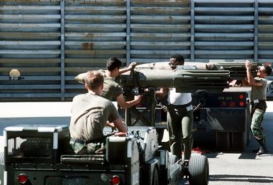 Members of the 43rd Bomb Wing's munitions loading team secure a Mark 82 500-pound bomb on an MJ-1 bomb loader during exercise Giant Warrior '89