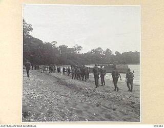 GAZELLE PENINSULA, NEW BRITAIN, 1945-05-15. TROOPS OF A COMPANY, 37/52 INFANTRY BATTALION, ARRIVING AT THE BEACH ON THE NORTH COAST OF NEW BRITAIN, PREPARE FOR EMBARKATION TO WATU PLANTATION
