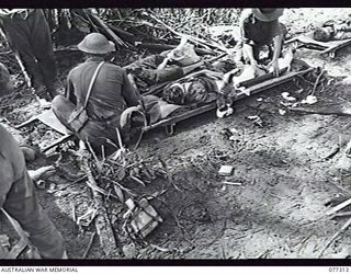 TOROKINA AREA, BOUGAINVILLE ISLAND. 1944-11-29. BATTLE CASUALTIES RECEIVING MEDICAL TREATMENT FOR WOUNDS RECEIVED DURING THE ATTACK BY D COMPANY, 9TH INFANTRY BATTALION, ON LITTLE GEORGE HILL