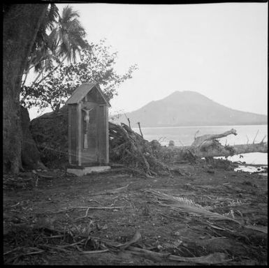 Shrine containing a crucifix surrounded by eruption devastation, Rabaul, New Guinea, 1937, 2 / Sarah Chinnery