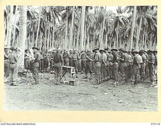 POTSDAM-HANSA BAY, NEW GUINEA. 1944-07-30. QX60086 CHAPLAIN G.D. SMITH CONDUCTING A CHURCH SERVICE AT THE 30TH INFANTRY BATTALION HEADQUARTERS IN THE POTSDAM PLANTATION