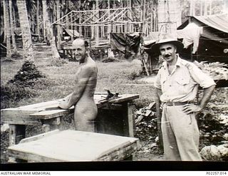 Madang, New Guinea, 1945-08-03. Stark naked, 82586 Flying Officer (FO) Allen Robert Griffiths (left), Administrative and Special Duties (A&SD) Intelligence, Headquarters, RAAF Northern Command ..