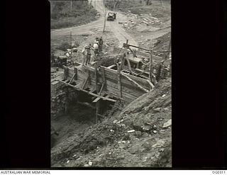 VIVIGANI, GOODENOUGH ISLAND, PAPUA. 1943-07-02. MOBILE WORKS SQUADRON USE A LOT OF "CHINAMEN" BUT WHITE AUSTRALIA ADVOCATES NEED NOT BE ALARMED. THIS CHINAMAN IS A STAGING FROM WHICH GRAVEL IS ..