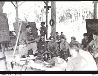 TOROKINA, BOUGAINVILLE, 1945-12-03. STUDENTS RECEIVING INSTRUCTION ON A SUBJECT IN THE ENGINEERING SECTION, TOROKINA REHABILITATION TRAINING CENTRE