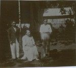 Three lepers in front of their kitchen