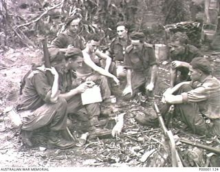 THE SOLOMON ISLANDS, 1945-04-24/27. A GROUP OF AUSTRALIAN SOLDIERS ON A COMPASS DIRECTION MAP READING EXERCISE ON BOUGAINVILLE ISLAND. (RNZAF OFFICIAL PHOTOGRAPH.)