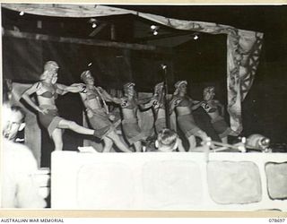 BOUGAINVILLE ISLAND. 1945-01-27. MEMBERS OF THE BALLET DOING A ROUTINE DURING A CONCERT STAGED BY THE 58/59TH INFANTRY BATTALION PLAYERS AT THE 2ND AUSTRALIAN CORPS HEADQUARTERS. IDENTIFIED ..